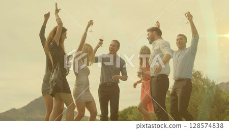 Image of smiling caucasian group of friends dancing with wine 128574838