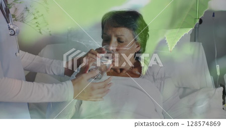 Mosquito stuck in a spider web against doctor giving medicines to senior caucasian woman 128574869