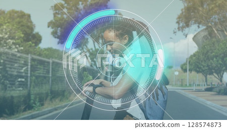 Neon round scanner against portrait of african american woman using her smartwatch on the street 128574873