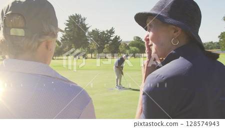 Image of light trails over senior caucasian couple on golf course 128574943