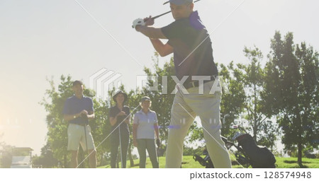 Image of light trails over senior caucasian couple playing golf on golf course Image of light trails over senior caucasian couple playing golf on golf course 128574948