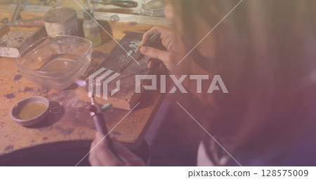 Image of caucasian female worker repairing in workshop 128575009