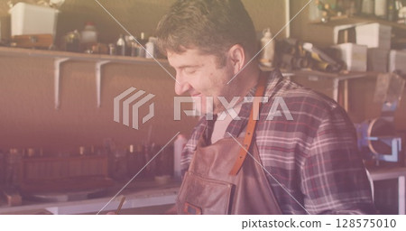 Image of caucasian male worker drawing in workshop 128575010