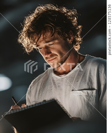 youtuber holding storyboard notebook in studio 128575136