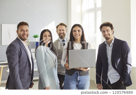 Successful smiling happy diverse professional business team standing in office looking at camera 128576989