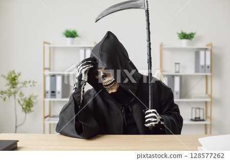 Confused Grim Reaper Working And Thinking At Office Desk Confused Grim Reaper Working And Thinking At Office Desk 128577262