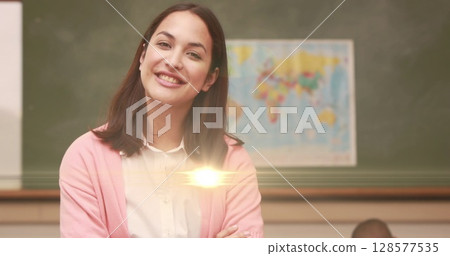 Image of light spots over happy caucasian female teacher in classroom 128577535