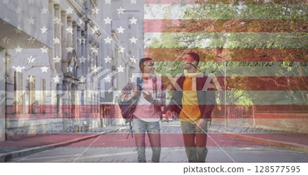 Image of american flag and constitution text over biracial male couple walking in city Image of american flag and constitution text over biracial male couple walking in city 128577595