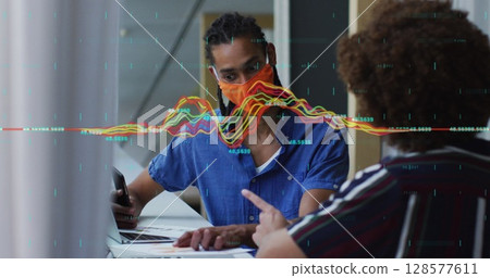 Image of data processing over diverse business people with face masks using laptops Image of data processing over diverse business people with face masks using laptops 128577611