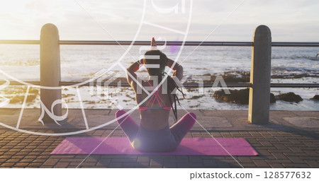 Horoscope circle against rear view of african american fit woman performing yoga on the promenade 128577632