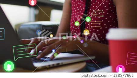 Image of media icons over african american businesswoman using laptop Image of media icons over african american businesswoman using laptop 128577665