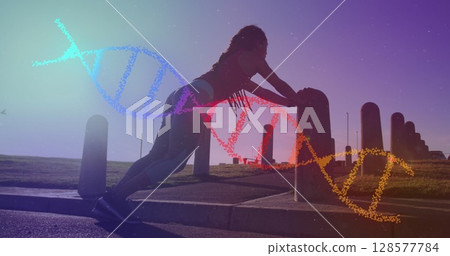 Image of dna strand over biracial woman exercising in park 128577784
