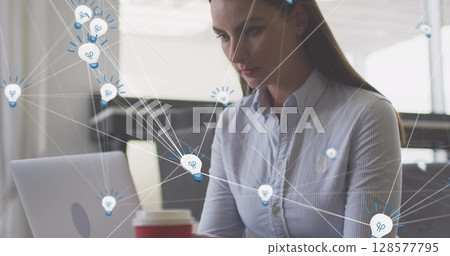 Image of media icons over caucasian businesswoman using laptop Image of media icons over caucasian businesswoman using laptop 128577795