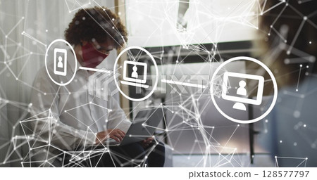 Image of media icons over biracial businessman with face mask Image of media icons over biracial businessman with face mask 128577797