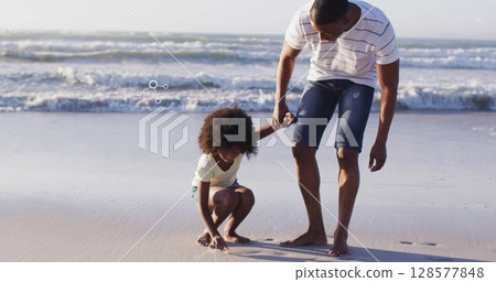 Image of molecules over african american afather and son picking up shells on beach at sunset Image of molecules over african american afather and son picking up shells on beach at sunset 128577848