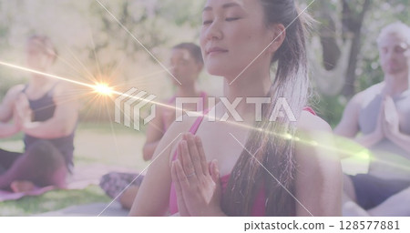 Image of light spots over diverse women practicing yoga and meditating Image of light spots over diverse women practicing yoga and meditating 128577881