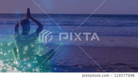 Image of light spots over senior caucasian woman practicing yoga and meditating 128577896