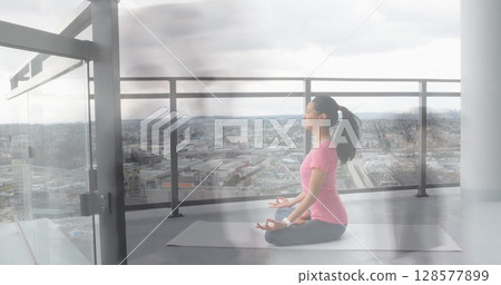 Image of walking people over asian woman practicing yoga and meditating Image of walking people over asian woman practicing yoga and meditating 128577899