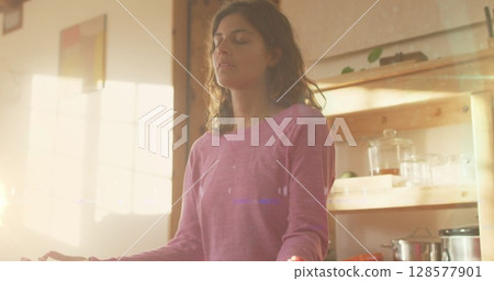 Image of light spots over caucasian woman practicing yoga and meditating 128577901