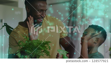 Image of lights over happy african american father and son watering plants and clapping hands Image of lights over happy african american father and son watering plants and clapping hands 128577921