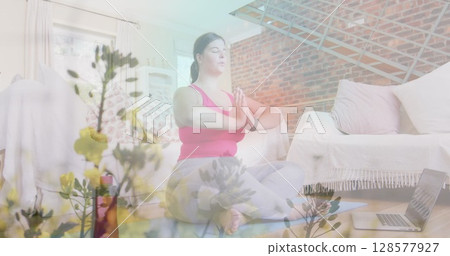 Image of flowers over caucasian woman practicing yoga at home 128577927