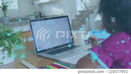 Image of network of connections with icons over biracial girl using laptop with copy space 128577951