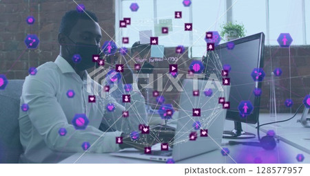 Image of network of connections with icons over african american man with face mask using laptop 128577957