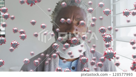 Image of virus cells over senior african american man with face mask 128577993