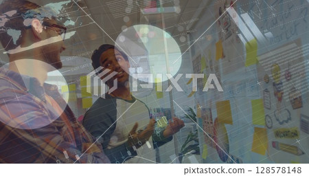 Image of graphs and financial data over diverse coworkers brainstorming in office 128578148