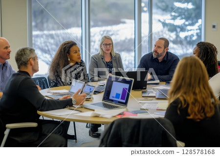 Business Professionals Engaged in a Collaborative Meeting in a Modern Office Setting During Daytime 128578168