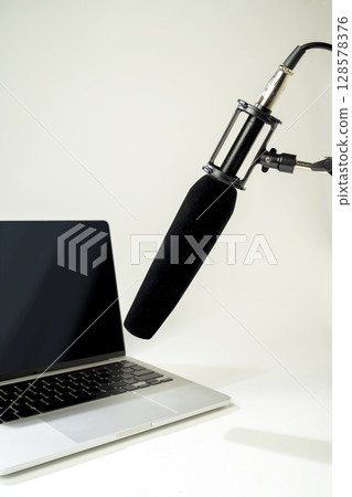 Studio microphone for podcasting or streaming on a boom arm with a laptop on a white background. Mockup or Copy space Studio microphone for podcasting or streaming on a boom arm with a laptop on a white background. Mockup or Copy space 128578376