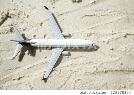 Airplane on a beautiful sandy beach. Natural background. Summer concept. Top view 128578393