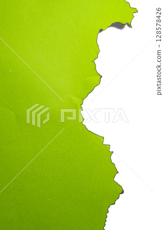 Green paper ripped message torn with burnt edges isolated on a white background. Copy space 128578426