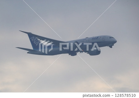 Rain clouds and passenger plane image 128578510
