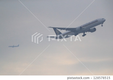 Rain clouds and passenger plane image 128578515