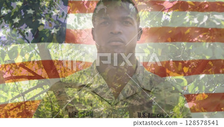 Image of american flag over african american soldier saluting and trees in background Image of american flag over african american soldier saluting and trees in background 128578541
