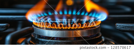 Close-Up of Lively Blue Flames on a Gas Stove 128578617