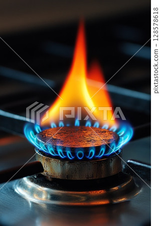 Close-Up of Lively Blue Flames on a Gas Stove 128578618