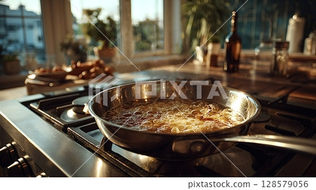 Hot boiling oil in frying pan on gas stove making dinner Hot boiling oil in frying pan on gas stove making dinner 128579056