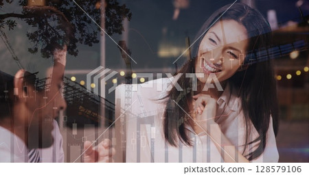 Image of financial data processing and cityscape over diverse business people 128579106