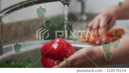 Image of pepper icons over caucasian man washing vegetables 128579134
