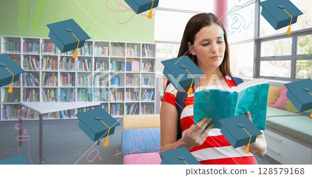 Image of graduation hats falling over caucasian female student with book 128579168