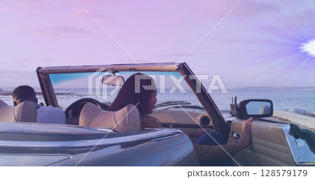 Image of happy diverse getting off cabriolet 128579179
