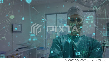 Image of network of connections with icons over smiling caucasian male surgeon Image of network of connections with icons over smiling caucasian male surgeon 128579183