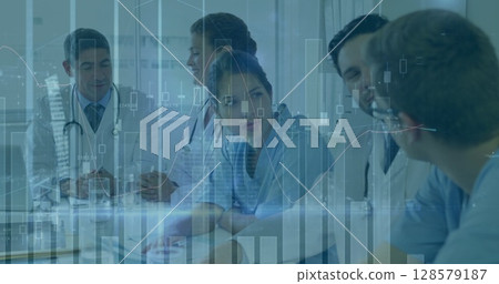 Image of graphs and data over diverse female and male doctors during consultation 128579187