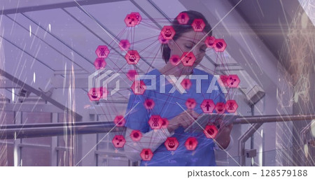 Image of network of connections with icons over smiling caucasian female doctor using tablet Image of network of connections with icons over smiling caucasian female doctor using tablet 128579188