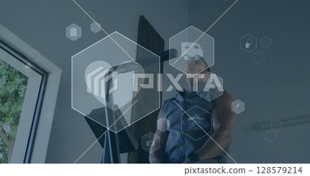 Image of medical and health icons over caucasian man exercising in gym 128579214