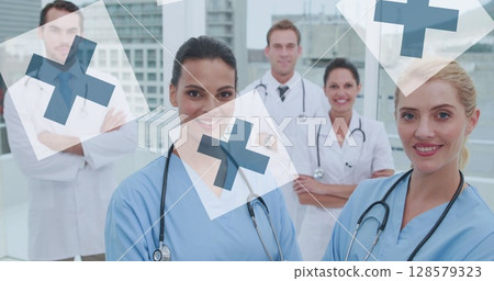 Image of diverse doctors over cross icons 128579323