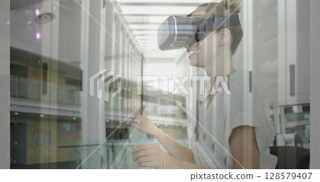 Image of women using vr headset over server room 128579407