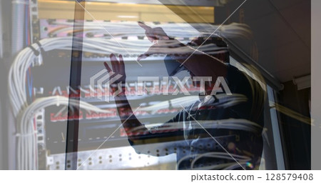 Image of men using vr headset over server room 128579408